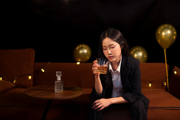  Closeup business woman holding a glass of whiskey