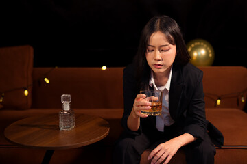 Closeup business woman holding a glass of whiskey
