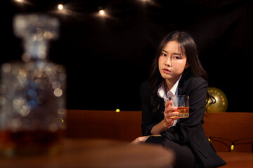 Closeup business woman holding a glass of whiskey
