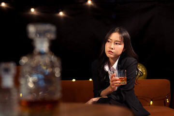 Closeup business woman holding a glass of whiskey