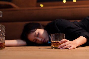  Closeup business woman holding a glass of whiskey