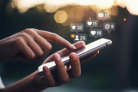 Woman's hand interacting with social media icons on phone
