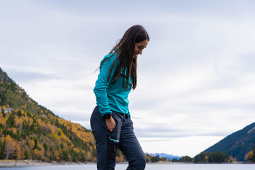 Woman by Sant Maurici Lake in autumn, Aigüestortes National Park, Pyrenees