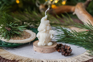 Handmade soy wax candles in the cozy room, Christmas lights in the background