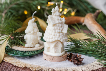 Handmade soy wax candles in the cozy room, Christmas lights in the background