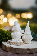 Handmade soy wax candles in the cozy room, Christmas lights in the background