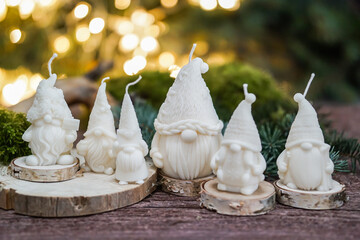 Handmade soy wax candles in the cozy room, Christmas lights in the background