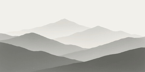 Misty blue mountain peaks and hills in the fog at sunrise, with a vast sky and cloud landscape view