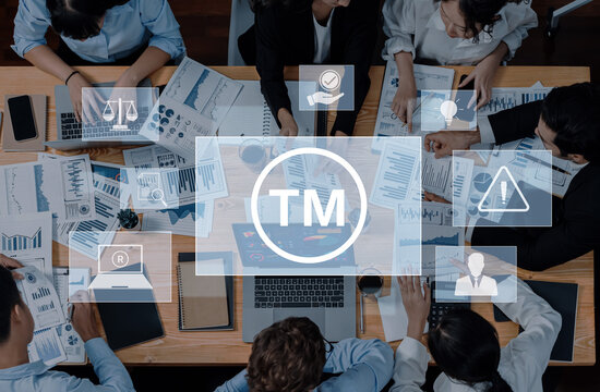 A dynamic business meeting showcasing professionals engaged in strategic planning, discussing data analyses, and sharing insights across various documents and visuals. Trope