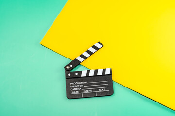 A movie clapperboard on a colorful background, ready for action in a vibrant and creative scene.