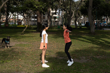 Two teenager are playing in a park