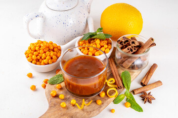 sea ​​buckthorn sauce with cinnamon, ginger and orange zest. Homemade autumn sauce, non sweet jam or chutney made with sea ​​buckthorn berries and spices, copy space