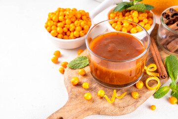 sea ​​buckthorn sauce with cinnamon, ginger and orange zest. Homemade autumn sauce, non sweet jam or chutney made with sea ​​buckthorn berries and spices, copy space