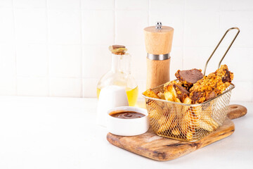 Beef Steak Nuggets Bites in crispy corn breading, cooked in an airfrier grill or oven. Healthy carnivore diet alternative nuggets. With barbecue sauce, spices and french fries potato chips