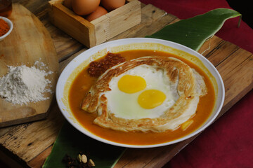 roti canai : Flaky Perfection: A light, pan-fried Malaysian flatbread with a crispy exterior and soft, layered interior. Served with our rich, aromatic dhal (lentil) and chicken curry for dipping.