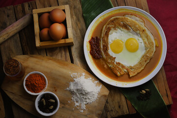 roti canai : Flaky Perfection: A light, pan-fried Malaysian flatbread with a crispy exterior and soft, layered interior. Served with our rich, aromatic dhal (lentil) and chicken curry for dipping.