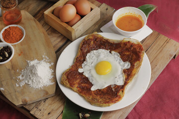 roti canai : Flaky Perfection: A light, pan-fried Malaysian flatbread with a crispy exterior and soft, layered interior. Served with our rich, aromatic dhal (lentil) and chicken curry for dipping.