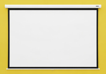 Blank projection screen extended on a bright yellow wall