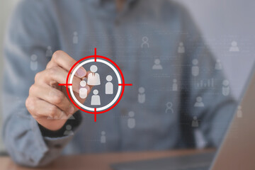 Business marketing position concept, businessman holds dart board icon with arrows for customer target group.	