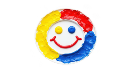 A colorful smiley face made of frosting on a white circular cake, isolated on transparent background