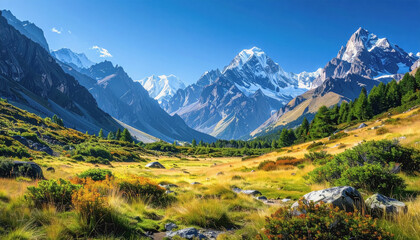 Serene mountain range with a stream in the foreground and clear blue sky with minimal space for copy
