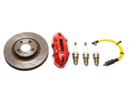 Isolated shiny new brake disc, caliper, spark plugs, spark plug wire on surface, auto components
