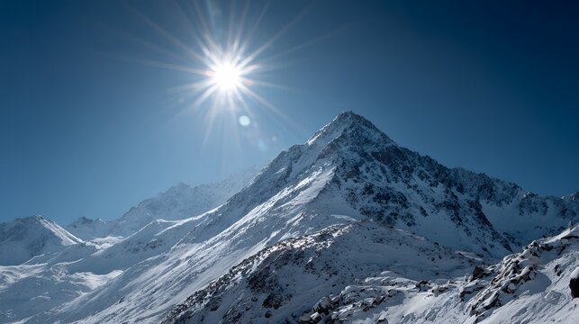 Bright midday sun radiates intensely above sharp snow covered mountain peaks