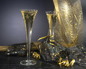 New Year concept, with bright light and champagne glass, abstract bokeh background