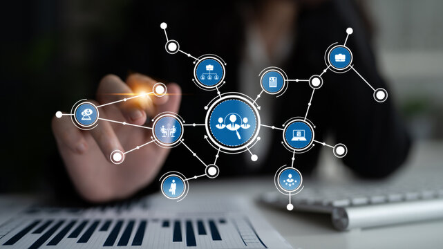 A businesswoman interacts with a digital touchscreen interface displaying network graphics, showcasing data visualization and connectivity in a professional workspace. Tessel - Powered by Adobe
