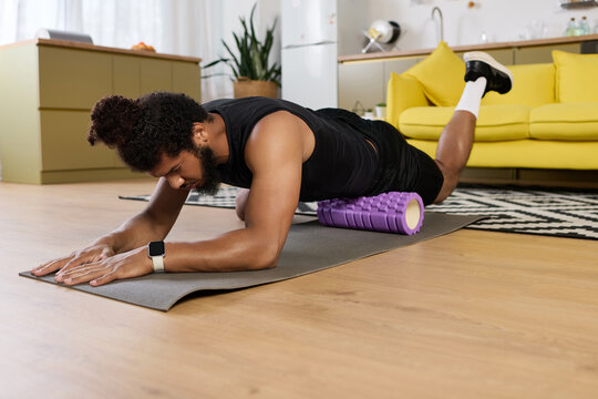 Focused workout session at home for a determined individual with a fit physique