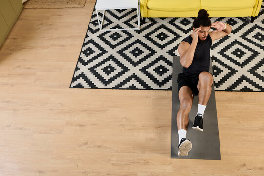 Focused athletic man engages in home workout routine on exercise mat - Powered by Adobe