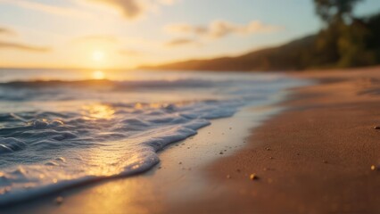 Soft-focus sunset over ocean waves gently lapping a sandy shore