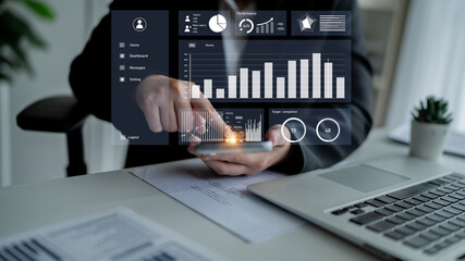 A business professional engages with advanced analytics on a smartphone within a modern office setting, showcasing digital charts and graphs for performance evaluation. Impute