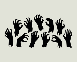 Obraz premium Silhouette of many reaching zombie hands emerging from the ground