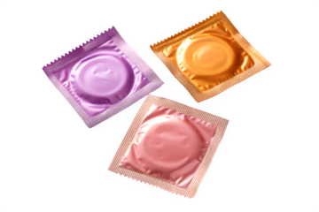 Three colorful condoms in foil packaging isolated on transparent background