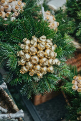Obraz premium Evergreen branches with golden seed pods decoration, close up view, natural elements