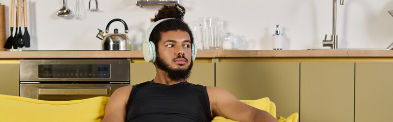 Home workout session of an athletic man with curly hair and headphones