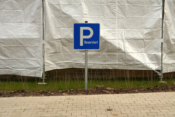 Parking lot sign written in german, reserviert, in englisch reserved