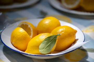 Fresh yellow lemons under natural sunlight
