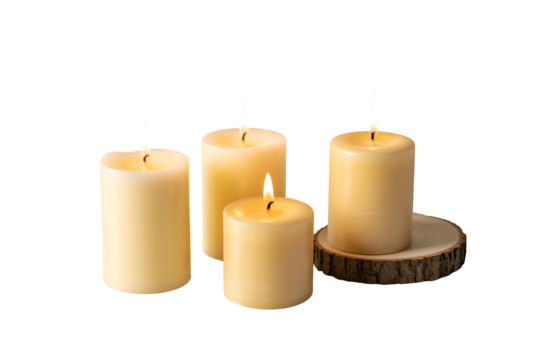 Four lit pillar candles on a rustic wooden base against a black background