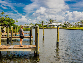 Female Tourist Standing on Boat Docks Along Boca Grande Bayou, Boca Grande, Florida, USA