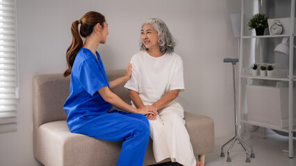 Obraz premium Asian Nurse Provides Compassionate Home Care to Senior Woman Empathy Support Companionship for Elderly Wellness