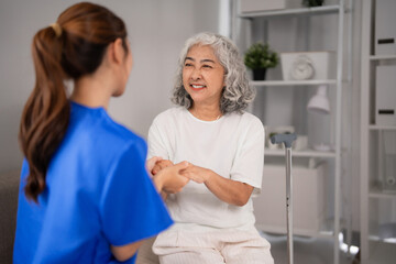 Obraz premium Asian nurse providing compassionate nursing care to older adult woman offering support empathy at home