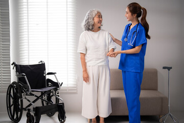 Asian nurse assisting older adult patient walking rehabilitation support home care medical professional aiding senior mobility physical therapy elderly health wellbeing service