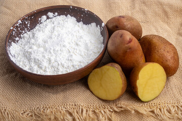 potato starch in a clay bowl on a linen tablecloth