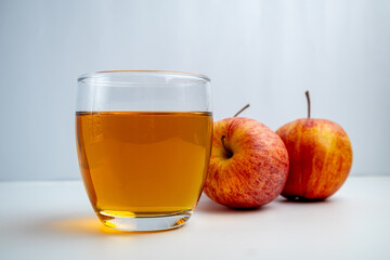 Apple juice in a glass on a white background