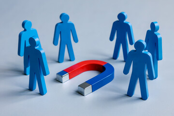 A Product Photography Shot of Blue Plastic Figures Being Attracted to a Red and Blue Horseshoe Magnet