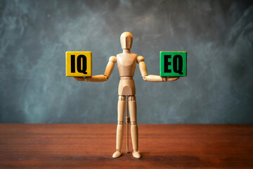 A Cinematic Ultra High Resolution Photograph of a Wooden Mannequin Balancing Yellow IQ and Green EQ Blocks