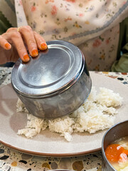 Serving Steamed White Rice from Metal Bowl onto Plate