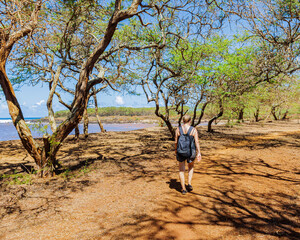 Female Hiker Walking on The Red Dirt at Dixie Maru Beach, Molokai, Hawaii, USA